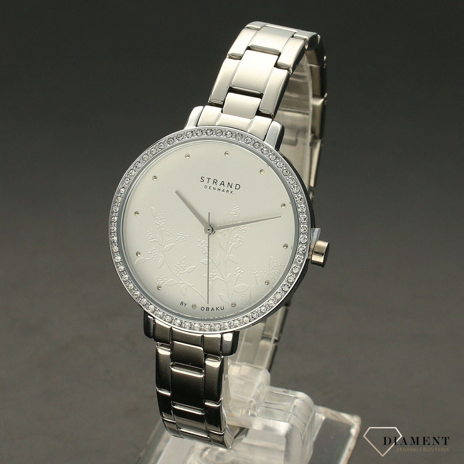 Zegarek damski STRAND Pacifica S712LXCISC. Strand Pacifica to elegancki zegarek damski z oryginalną, białą tarczą ozdobioną kwiatowym motywem. Zegarek damski posiada indeksy ze srebra. Tarcza ozdobiona jest błyszczą8.jpg