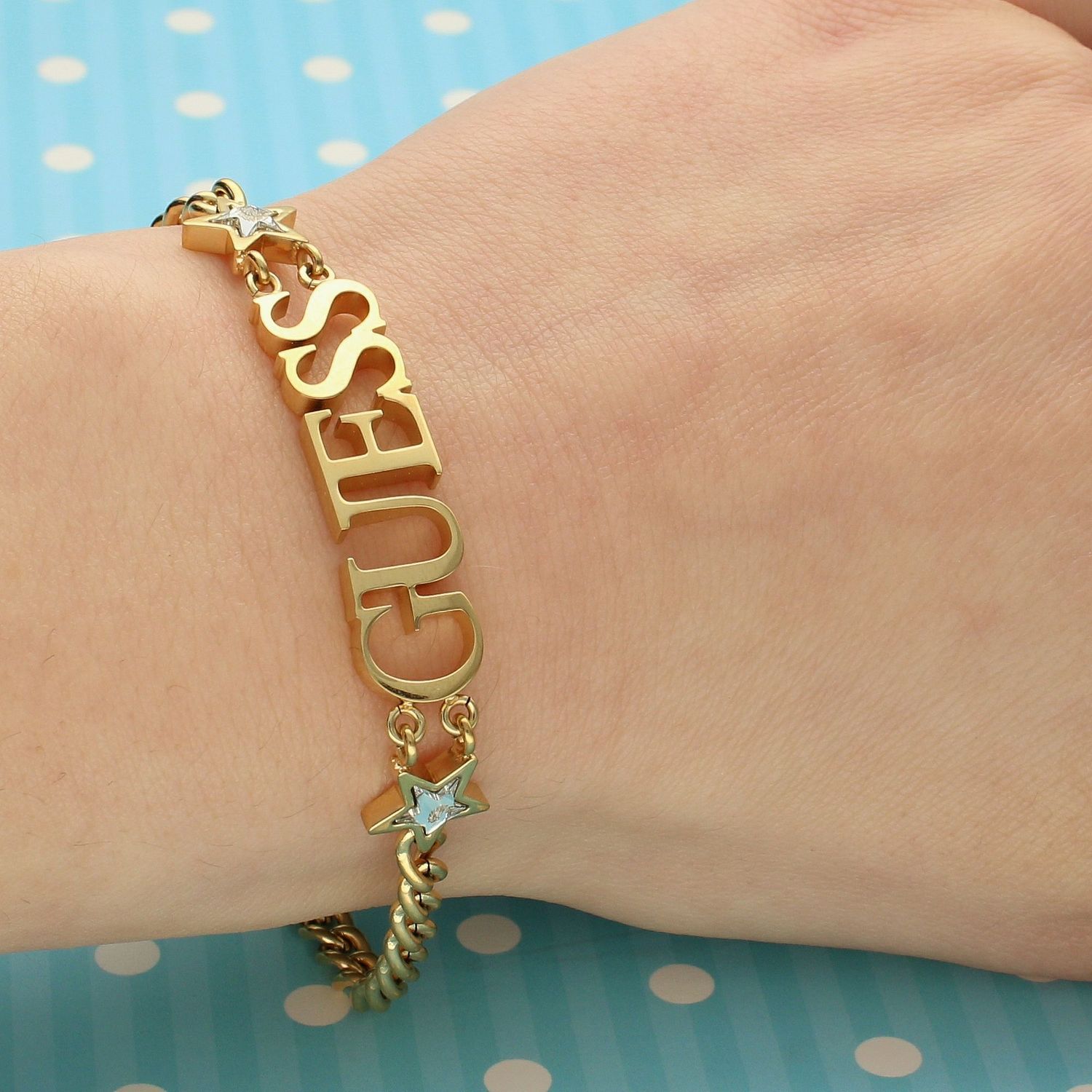 Bransoletka pozłacana duży napis GUESS UBB70076-S.jpg