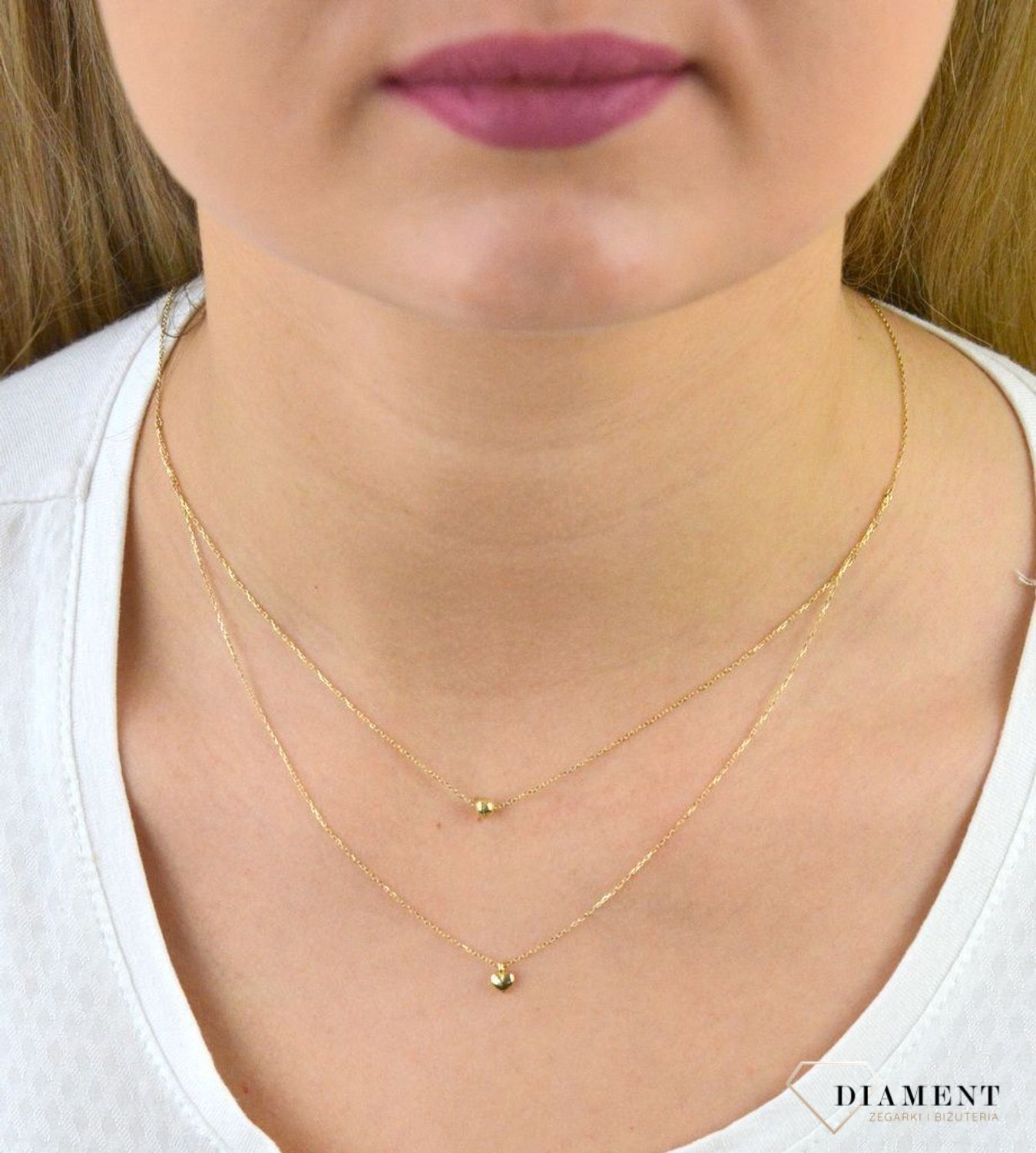 Złoty naszyjnik próby 333 serce z kuleczką ZW-X-X09-N45-CA18582. Złoty naszyjnik celebrytka warstwowa z elementami ozdobnym w postaci serca i kulki. Wykonana ze 8-karatowego żółtego złota, próba 333.png